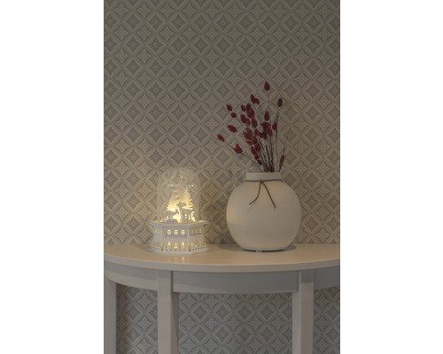 Dekoration mit Leuchthaus, Vase und Trockenblumen auf einem Tisch