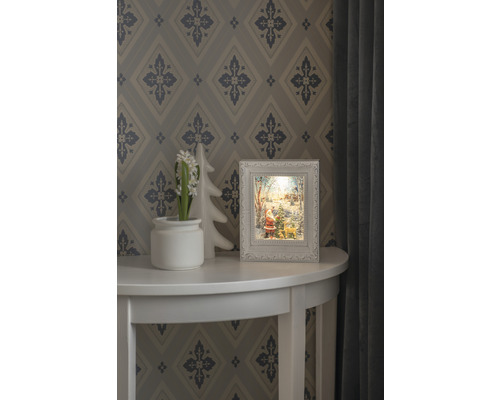 Dekorative Weihnachtsszene mit beleuchtetem Rahmen auf einem Tisch