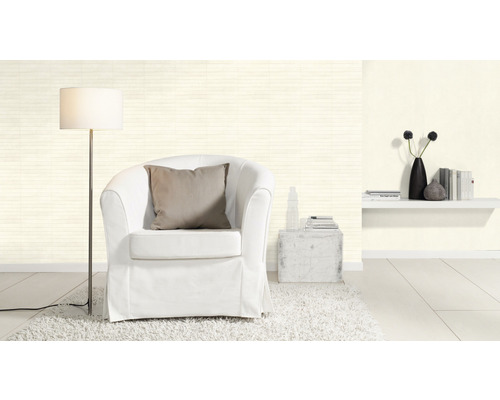 Helles Wohnzimmer mit Sessel, Stehlampe und Wandregal