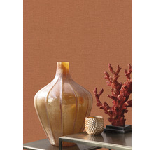 Scène décorative avec vase, corail et bougeoir sur une table devant un mur