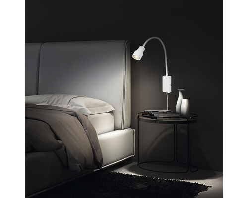 Chambre à coucher avec lit, table de chevet et applique murale blanche