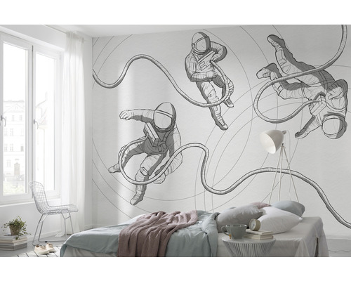 Chambre à coucher avec un papier peint photo représentant des astronautes sur le mur