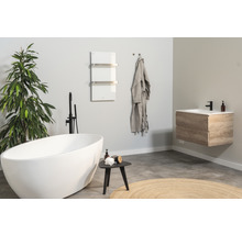 Salle de bains lumineuse avec baignoire îlot, meuble sous-lavabo et sèche-serviettes