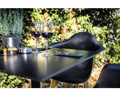 Scène avec table dressée, verres à vin et décoration en extérieur