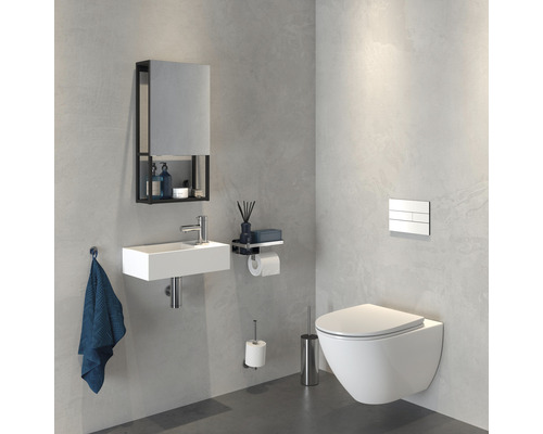 Salle de bains moderne avec WC suspendu, lavabo, armoire de toilette et accessoires.