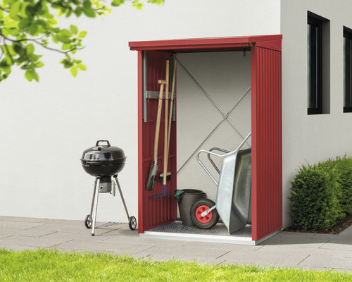 Armoire à outils avec outils de jardin et barbecue devant un mur de maison