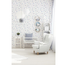 Chambre d''enfant lumineuse avec lit de bébé, fauteuil et papier peint à motifs