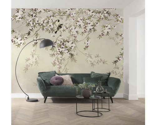 Wohnzimmer mit floraler Tapete, Sofa, Stehlampe und Beistelltischen