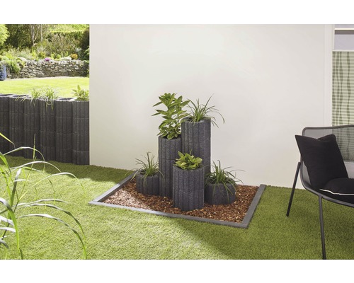 Idée d''aménagement de jardin avec des pierres à plantes et des plantes sur une pelouse.