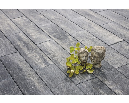 Pose de pavés gris avec deux statues