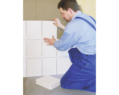 Carreleur travaillant avec des carreaux muraux