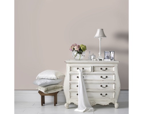 Chambre décorative avec commode, lampe et pile d''oreillers