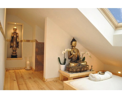Intérieur avec statues de Bouddha, table de massage et plancher en bois