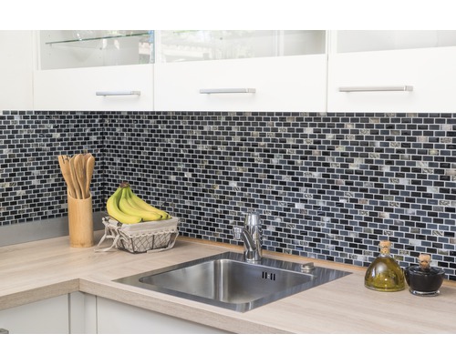 Küchenspüle mit Mosaikfliesen-Wand und Küchenutensilien