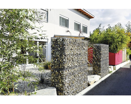 Gabionen mit Steinen im Garten vor einem Haus