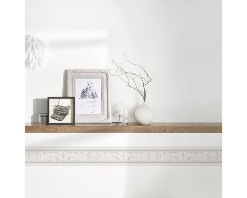 Salon avec bordure et décoration sur une étagère murale.