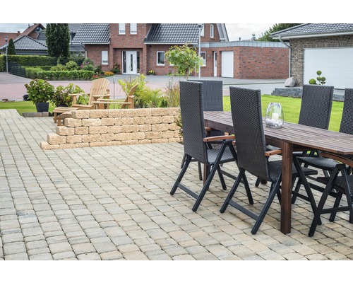 Extérieur avec terrasse pavée, mur de jardin et coin salon