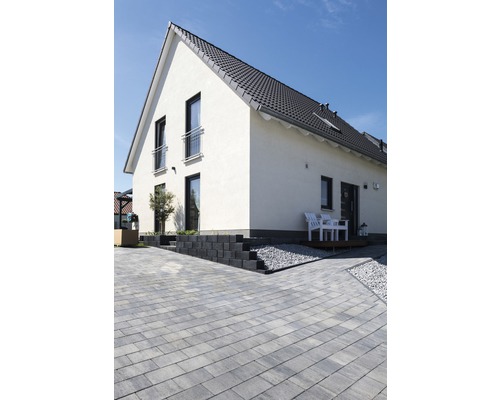 Vue extérieure d''une maison d''habitation avec pavés, marches d''escalier et terrasse