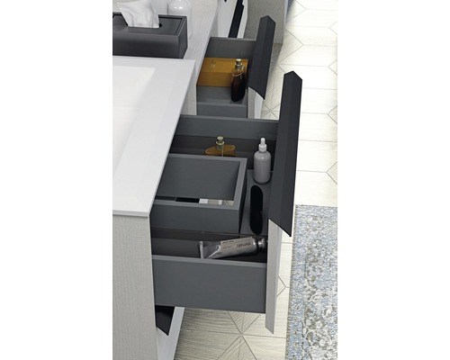 Meuble sous-lavabo de salle de bains avec tiroirs ouverts pour ranger les accessoires de salle de bains