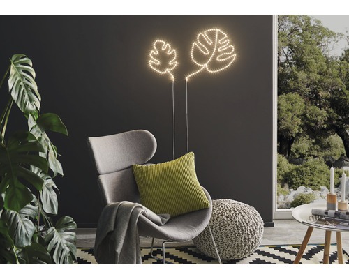 Dekoratives Wohnzimmer mit Blatt Leuchten, Sessel und Zimmerpflanze