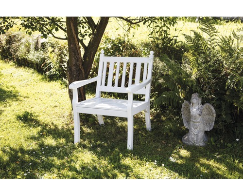 Banc de jardin en bois blanc dans le jardin à côté d''une statue d''ange