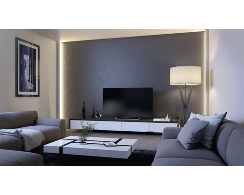 Wohnzimmer mit Sofa, Fernseher und Stehlampe