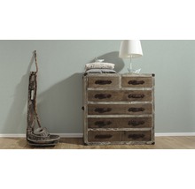 Commode en bois avec six tiroirs, lampe et décoration
