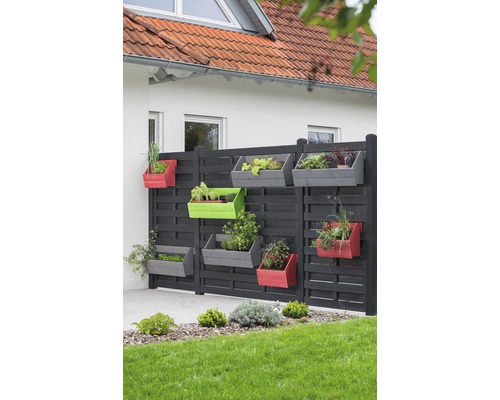 Mur décoratif en bois avec jardinières colorées dans le jardin.