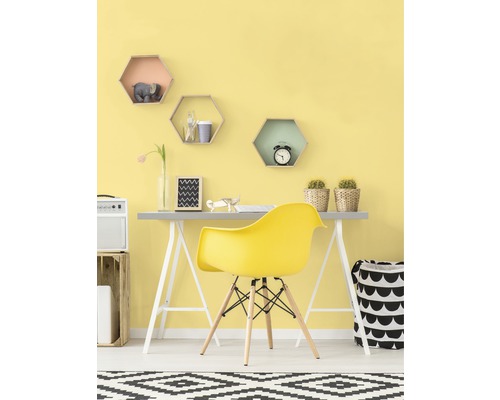 Bureau lumineux avec un bureau, une chaise jaune et des étagères décoratives