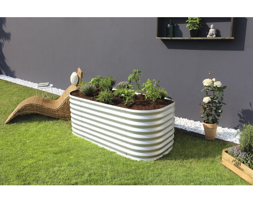 Jardinière surélevée en métal avec plantations dans le jardin