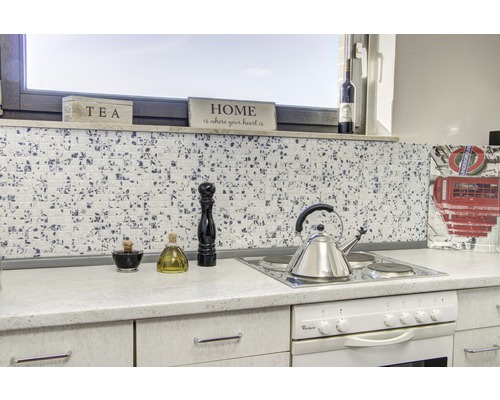 Küchenszene mit Mosaikfliesen, Kochfeld, Wasserkocher und Küchenutensilien