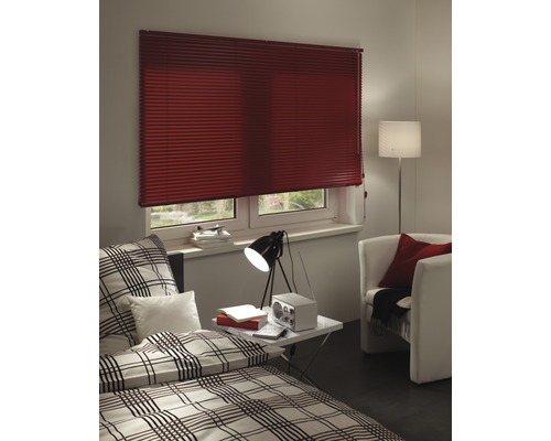 Schlafzimmer mit Plissee am Fenster, Bett und Sessel