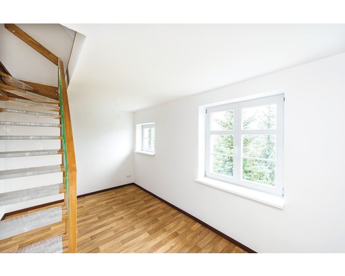 Pièce lumineuse avec escalier en bois, parquet et fenêtres