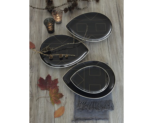 Arrangement décoratif avec des assiettes noires à motifs géométriques