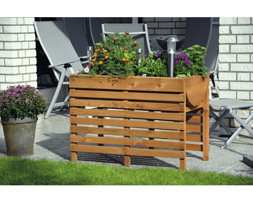 Jardinière surélevée sur pilotis 100x50x71 cm ambre jaune Jardinière en bois avec des fleurs et des lampes solaires sur une terrasse