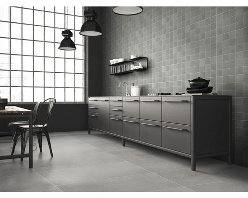 Cuisine claire de style industriel avec kitchenette, carreaux muraux carrés et table à manger