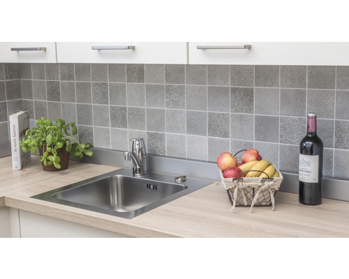 Évier de cuisine avec robinet sur un plan de travail avec crédence carrelée