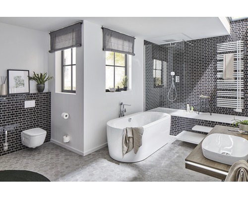 Helles Badezimmer mit Badewanne, Waschtisch, Toilette und Dusche