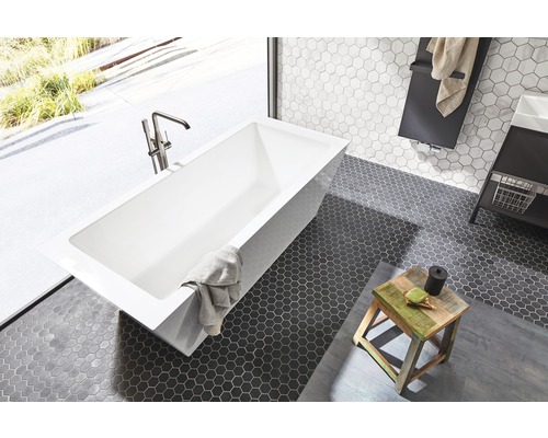 Salle de bain moderne avec baignoire îlot, carreaux de mosaïque et tabouret en bois