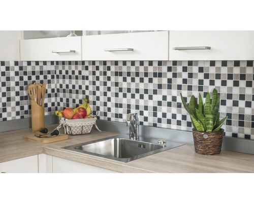 Évier de cuisine avec robinet, carreaux de mosaïque et ustensiles de cuisine sur un comptoir