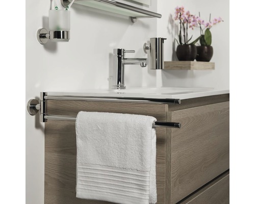 Lavabo de salle de bains avec robinet, porte-serviettes, serviette, distributeur de savon, gobelet à brosse à dents et étagère