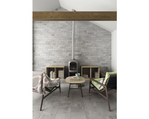 Salon avec mur en pierre, fourneau, poutres en bois et sièges