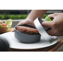 Burgerpresse mit Hackfleisch auf einem Teller