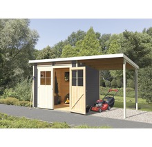 Abri de jardin en bois avec annexe et tondeuse à gazon dans le jardin