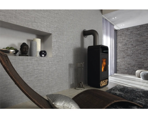 Salon avec poêle à bois, chaise longue et décoration murale