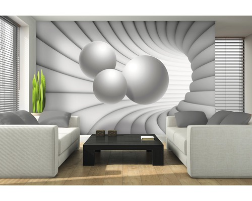 Salon avec papier peint photo à motif de sphères 3D derrière deux canapés blancs