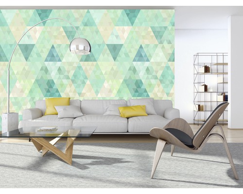 Salon avec canapé, fauteuil, table basse et papier peint géométrique