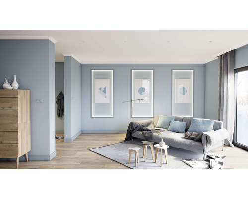 Salon avec canapé, tapis, éclairage et décoration murale dans un design clair