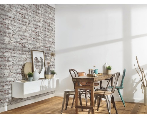 Pièce à vivre avec papier peint en briques, étagère et table à manger avec chaises.