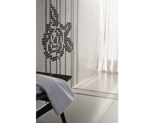 Salle de bains avec mur en mosaïque, tabouret en bois et serviettes